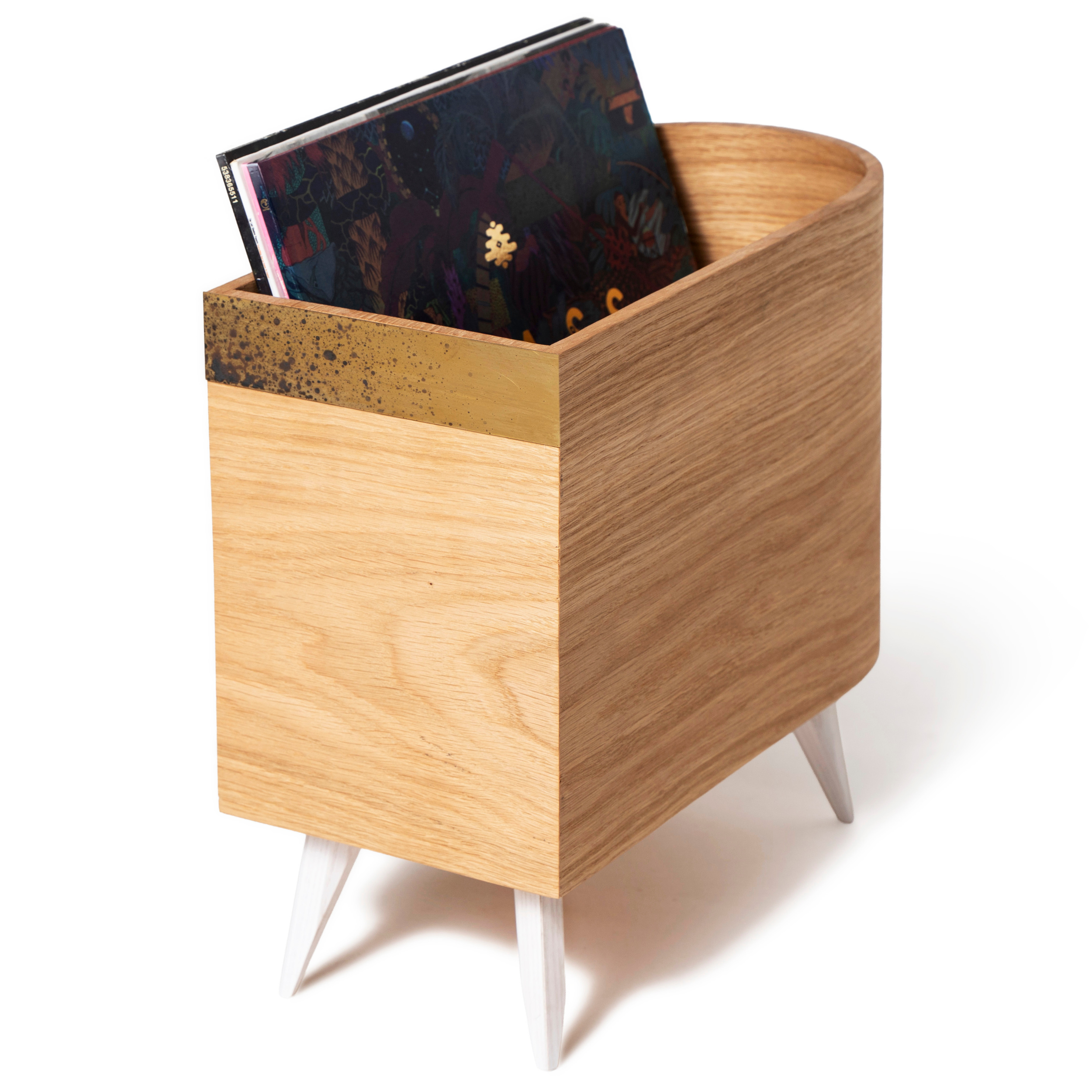 Wooden vinyl record shelf with brass plate on front and white wooden legs